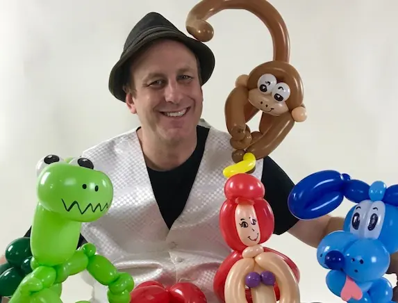 Eric The Magic Guy surrounded by balloon animals he twisted